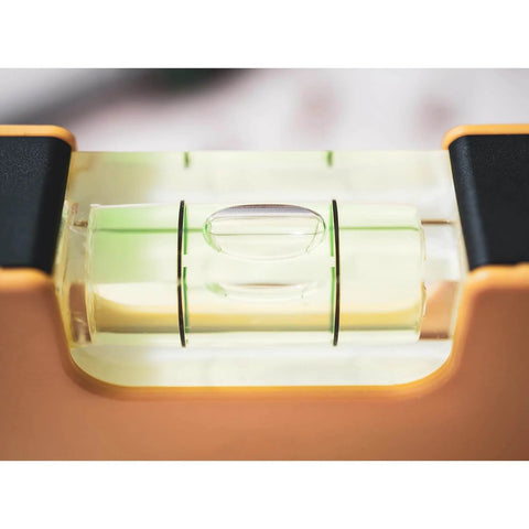 Close-up of a cylindrical bubble level in use, part of a set of four compact cylindrical bubble levels delivering fast, precise one-hand leveling.