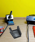 Upgraded Silicone Soldering Stand with six slot wire holder for 32AWG to 12AWG wires on workbench, dark grey, heat shrink reminder