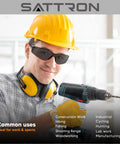 Person wearing Dark Tinted Safety Glasses 24 Pack ANSI Z87 UV Eye Protection For Construction, using a power drill.