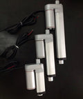 Three 24V DC Linear Actuators With 50mm Stroke 750N Lift IP65 Aluminum Housing showing different sizes, on black background.