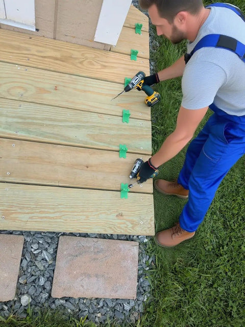 Installer using 4 In 1 ABS Deck Spacer Tools Set for Accurate Deck Gaps with Four Sizes One Sixteenth One Eighth Three Sixteenths and One Quarter Inch Pro Grade Reusable Green 9 Pack for Pressure Treated and Composite Decking