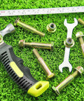 Two Pack Deck Wheel Shoulder Bolts And Flanged Locknut Kit For Half Inch Bore Wheels with tools on grass background
