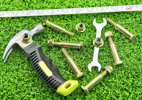 Two Pack Deck Wheel Shoulder Bolts And Flanged Locknut Kit For Half Inch Bore Wheels with tools on grass background