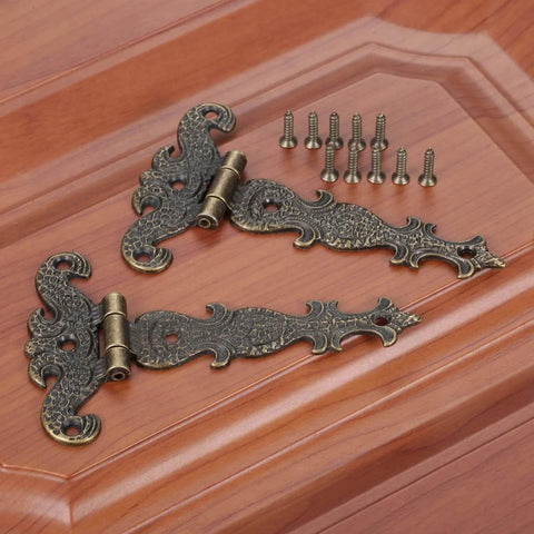 Two Piece Black T Strap Decorative Furniture Hinges Zinc Alloy Butt Hinges for cabinets on wooden surface; size 113 by 69 mm.
