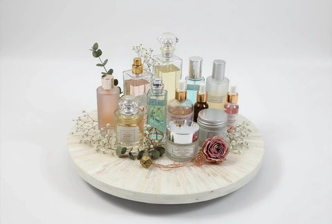 12.6 inch decorative lazy susan turntable with mother of pearl inlay, displaying various perfume bottles and floral accents.