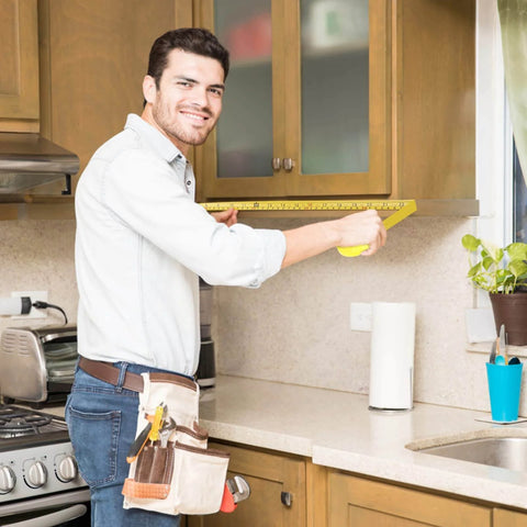 Man using 2 Packs Tape Measure 25 ft /16 ft, Esydon Measuring Tape Extendable, in a kitchen for cabinet measurements