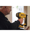 DEWALT 20V MAX cordless 18GA brad nailer kit in use for installing interior trim with brushless motor, adjustable depth, LED work light.