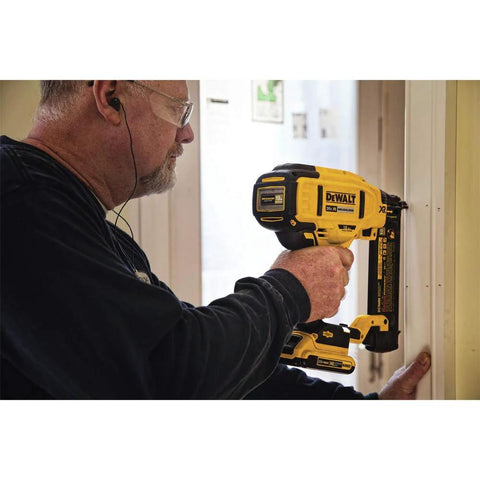DEWALT 20V MAX cordless 18GA brad nailer kit in use for installing interior trim with brushless motor, adjustable depth, LED work light.
