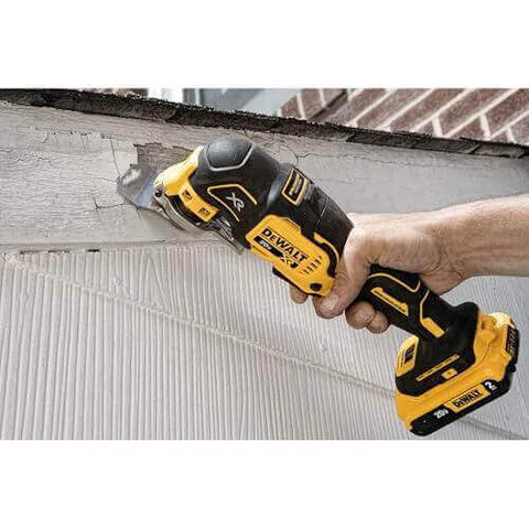 Person using DEWALT 20V MAX XR Cordless Oscillating Multi Tool With Variable Speed Brushless Motor on wood surface