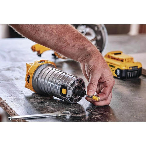 Person adjusting the 20V Max XR Cordless Brushless Router with Variable Speed Dual LEDs and Precise Depth Adjustment on workbench.