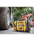 DEWALT Tire Inflator Portable Air Compressor 20V MAX, Car Air Pump with Automatic Shut Off next to car tire