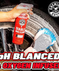 Hand holding Diablo Wheel Cleaner Spray Two Pack 16 Oz Bottles near a wheel, with brush cleaning tire, text 'pH Balaced & Oxygen Infused.'