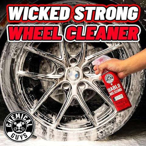 Hand spraying Diablo Wheel Cleaner on chrome wheel to remove brake dust and grime, showcasing safe use on custom wheels.
