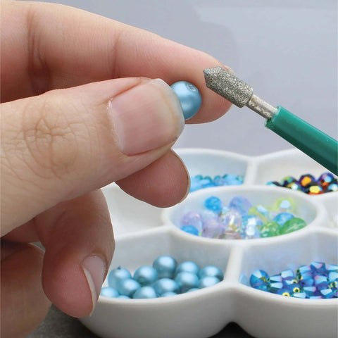 Diamond Tipped Bead Reamer Set For Jewelry Making With Color Coded Plastic Handles A Four Piece Steel Diamond Drill Kit To Enlarge Holes And Smooth Edges The Beadsmith close-up view of tool in use on a bead, showing detail of drill tip.