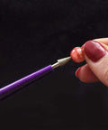 Diamond Tipped Pro Grade Bead Reamer Set For Jewelry Making And Beading Tools 10 Piece Kit in use on bead with plastic handle visible