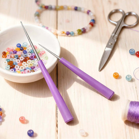 Diamond Tipped Bead Reamer Kit For Jewelry Making 2 Piece Set with pink handles beside colorful beads and scissors.