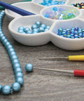 Diamond Tipped Bead Reamer Set For Jewelry Making With Color Coded Plastic Handles A Four Piece Steel Diamond Drill Kit To Enlarge Holes And Smooth Edges The Beadsmith with turquoise beads and a bead tray.