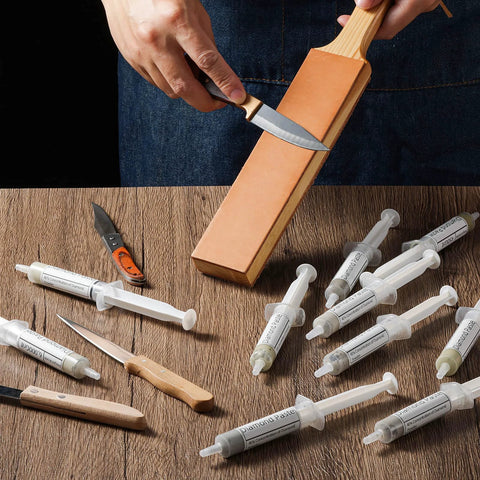 Extra Large Diamond Polishing Compound Kit 100g With Ten Tubes Of Forty Percent Diamond Paste Grit 450 To 80000 For Metal Glass Jewelry Resin Marble Watches And Watch Dials Polishing And Finishing Kit, syringes on table, hand polishing knife on leather strop