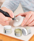 Person using 80000 Grit Diamond Polishing Paste With Twenty Five Percent Diamond Powder Point One Micron on stone with tool
