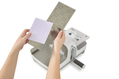 All In One 6 Inch Die Cutting And Embossing Machine Starter Kit For Crafters Includes Cutting Dies Embossing Folder Cardstock And Accessory Pack Compatible With Sizzix Big Shot For Scrapbooking And DIY Card Making showing die insertion