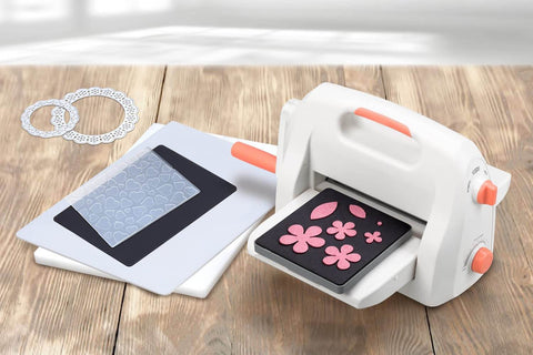9 Inch Adjustable Die Cutting And Embossing Machine Starter Kit with pink floral die and accessories on wooden table