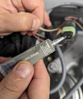 Applying Permatex 81150 Dielectric Tune-Up Grease, 0.33 oz. Tube, Silver to an automotive electrical connection.