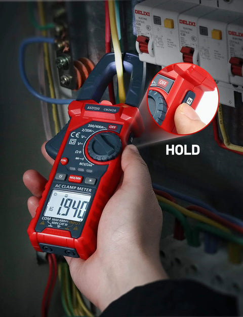 Hand using Digital Clamp Meter Multimeter 2000 Counts Amp Voltage Tester Auto-ranging with AC/DC Voltage, Blue, on electrical panel.