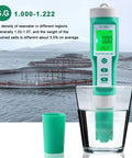 Hydrogen Water Tester 10 In 1 Digital Water Meter in glass near fish farm, showing S.G. measurement on screen