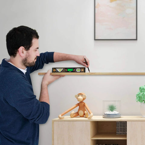 Person using a digital level with 11.5 inch LCD display and 360 degree inclinometer for vertical and horizontal angles on a shelf.