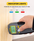 Hand using Digital Moisture Meter, Water Leak Detector, Moisture Tester, Pin Type, Backlit LCD Display With Audible and Visual High-Medium-Low Alerts