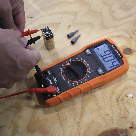 Hands using Multimeter, Digital Manual-Ranging 600V AC/DC Voltage Tester, Tests Batteries, Current, Resistance, Diodes, and Continuity