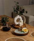 Table setting featuring a 12 inch acacia wood lazy susan turntable with removable glass plate, serving cheese and snacks.