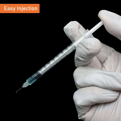 Gloved hand holding disposable sterile 1ml syringe with 31G 8mm needle, suitable for insulin and precise dosing, black background.