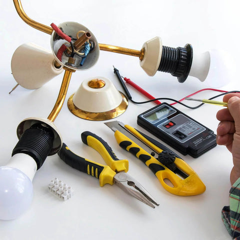 Disassembled chandelier with tools showcasing Lamp Pipe Kit With Lock Nuts And Washers For Chandelier Ceiling Light DIY One Eighth IP Thread Zinc Plated Steel.