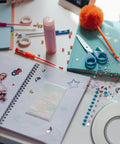 Scrapbooking supplies including stickers, scissors, and Heavy Duty Double Sided Foam Tape With Crazy Sticky Adhesion, white roll