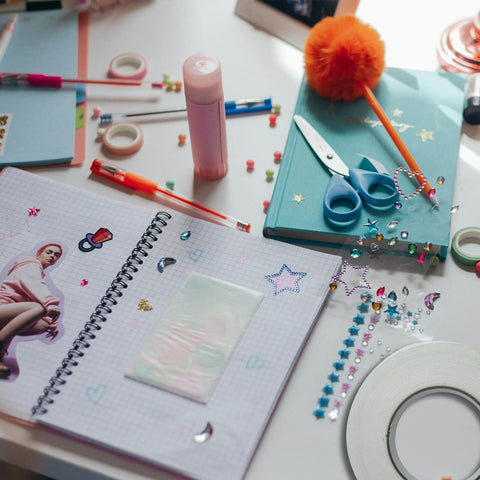 Scrapbooking supplies including stickers, scissors, and Heavy Duty Double Sided Foam Tape With Crazy Sticky Adhesion, white roll