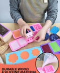 Person using DIY Soap Making Kit For Adults And Kids With Rectangular Loaf Mold, silicone molds, and wooden cutters on table