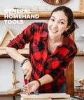 Person using a screwdriver on a wooden project in a workshop setting.