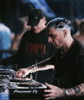 DJ wearing high fidelity reusable earplugs with blue filters for concerts and live music offering superior noise reduction hearing protection