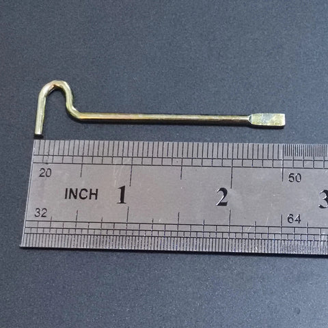 Single emergency key for interior privacy doors next to a ruler, showing size and durable metal construction for bedroom and bathroom use.