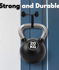 20 kg kettlebell hanging on wall hook demonstrating strength and durability against blue background