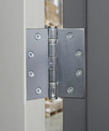 Commercial 4 Pack 4.5 Inch Ball Bearing Door Hinges Satin Chrome Finish installed on metal door frame