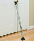 Adjustable Door Security Bar With Vibration Detecting Alarm And 115 Decibel Siren That Emits Up To 1100 Feet For Hinged And Sliding Doors Rubberized Foot For Strong Grip Collapsible Design For Easy Storage And Indoor Use Only installed on a white door