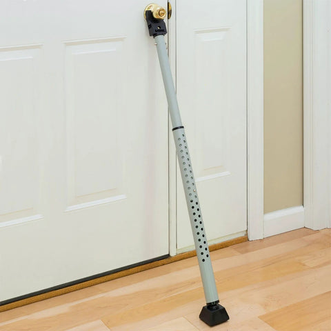 Adjustable Door Security Bar With Vibration Detecting Alarm And 115 Decibel Siren That Emits Up To 1100 Feet For Hinged And Sliding Doors Rubberized Foot For Strong Grip Collapsible Design For Easy Storage And Indoor Use Only installed on a white door