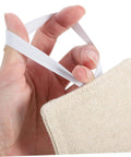 Close-up of hand holding beige fabric with elastic strap, part of three-piece, no-tool door silencers preventing finger pinches and noise.