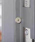 Close-up of Heavy Duty Commercial Door Silencer Kit For Metal Frames Replacement Absorbs Shock And Cuts Noise 12 Pack installed on door