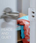 Door Silencer Strike Plate With Adhesive Bump Stops For Loud Doors No Drills Required Easy No Tools Install Flexible Noise Eliminating Solution That Stops Slamming Noises White Finish installed on door jamb next to a blurred open door.