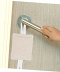 Three Pack Door Slam Stoppers Silencers for Doors Prevent Slamming with Easy No Drill Installation Attach to Door Knobs Without Tools Safe for Kids and Bedrooms in use on a doorknob.