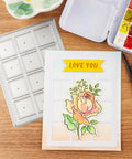 Dotted Square Frame Cutting Die Set for Card Making and Scrapbooking beside a decorated love card with floral design
