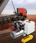 Double Acting 4 Way Hydraulic Pump Power Unit With 12V DC Motor 2 GPM Flow 3200 PSI Max next to a dump trailer in operation